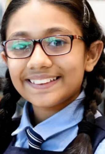 girl with glasses smiling